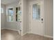 Home entry with white door, glass accents, and tile flooring at 20363 Symphony Pl, Venice, FL 34293