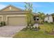 Two-car garage home with walkway and nicely landscaped front yard at 20363 Symphony Pl, Venice, FL 34293