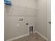 Convenient laundry room with shelving and built-in utility sink at 20363 Symphony Pl, Venice, FL 34293