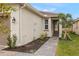Walkway to front entrance with landscaping and exterior lighting at 20375 Symphony Pl, Venice, FL 34293