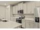 Modern kitchen with stainless steel appliances and white cabinets at 20375 Symphony Pl, Venice, FL 34293