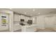 Modern kitchen with island and stainless steel appliances at 20375 Symphony Pl, Venice, FL 34293