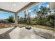 Covered patio with fire pit and spacious backyard at 6454 Freeport Dr, Spring Hill, FL 34608