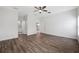 Bright bedroom featuring hardwood floors and ceiling fan at 6454 Freeport Dr, Spring Hill, FL 34608