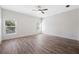 Well-lit bedroom with hardwood floors and two windows at 6454 Freeport Dr, Spring Hill, FL 34608