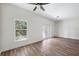 Bright bedroom with wood-look floors and French doors at 6454 Freeport Dr, Spring Hill, FL 34608