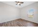 Bright bedroom with wood-look floors and ceiling fan at 6454 Freeport Dr, Spring Hill, FL 34608