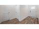 Bright entryway with wood-look floors and white doors at 6454 Freeport Dr, Spring Hill, FL 34608