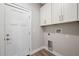 Laundry room with white cabinets and vinyl flooring at 6454 Freeport Dr, Spring Hill, FL 34608