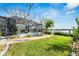 Landscaped backyard with a walkway leading to a waterfront view at 6613 Seabird Way, Apollo Beach, FL 33572