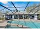Inviting kidney-shaped pool with a screened enclosure and patio at 6613 Seabird Way, Apollo Beach, FL 33572