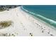 Beachfront property aerial view, showing beach with people at 11000 Gulf Blvd # 703, Treasure Island, FL 33706