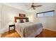 Comfortable bedroom with hardwood floors and ceiling fan at 11000 Gulf Blvd # 703, Treasure Island, FL 33706