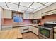 Kitchen features updated appliances and wood cabinets at 11000 Gulf Blvd # 703, Treasure Island, FL 33706