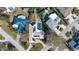 Aerial view of a house with a pool and solar panels at 411 Belle Isle Ave, Belleair Beach, FL 33786