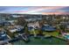 Wide aerial showcasing waterfront property, boat docks, and neighboring houses at 411 Belle Isle Ave, Belleair Beach, FL 33786