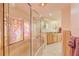 Elegant bathroom with a large shower, garden tub, and stained-glass window at 411 Belle Isle Ave, Belleair Beach, FL 33786