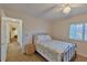 Cozy bedroom with ceiling fan and access to hallway bathroom at 411 Belle Isle Ave, Belleair Beach, FL 33786