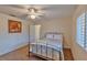 Bright bedroom with ceiling fan and window with plantation shutters at 411 Belle Isle Ave, Belleair Beach, FL 33786