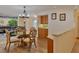 Dining area with a glass-top table and wooden chairs near the kitchen at 411 Belle Isle Ave, Belleair Beach, FL 33786