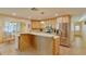 Open kitchen with island, stainless steel appliances, and breakfast nook at 411 Belle Isle Ave, Belleair Beach, FL 33786