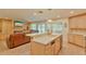 Spacious kitchen with island, stainless steel appliances, and ample cabinetry at 411 Belle Isle Ave, Belleair Beach, FL 33786
