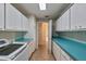 Laundry room with teal countertops, washer, and dryer at 411 Belle Isle Ave, Belleair Beach, FL 33786