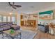 Open living and dining area with leather sectional, large TV, and hardwood floors at 411 Belle Isle Ave, Belleair Beach, FL 33786