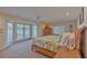 Main bedroom with water views and access to the pool area at 411 Belle Isle Ave, Belleair Beach, FL 33786