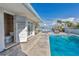 Inviting pool area with adjacent bathroom and water views at 411 Belle Isle Ave, Belleair Beach, FL 33786