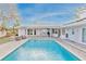Inviting pool with patio and covered lanai at 411 Belle Isle Ave, Belleair Beach, FL 33786