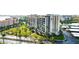Aerial view highlighting condo building, palm trees, and roadside at 7400 Sun Island Dr # 501, South Pasadena, FL 33707