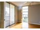 Bedroom with hardwood floors and sliding glass doors leading to a balcony at 7400 Sun Island Dr # 501, South Pasadena, FL 33707
