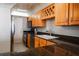 Bright kitchen with wood cabinets, granite countertops, and stainless steel appliances at 7400 Sun Island Dr # 501, South Pasadena, FL 33707