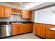 Well-equipped kitchen with wood cabinets and granite countertops at 7400 Sun Island Dr # 501, South Pasadena, FL 33707