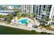 Community pool with spa and surrounding patio area at 7400 Sun Island Dr # 501, South Pasadena, FL 33707