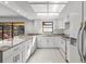 Bright kitchen featuring white cabinetry, granite countertops, and stainless steel appliances at 2233 Curlew Rd, Dunedin, FL 34698