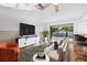 Bright living room with sliding glass doors leading to a screened pool at 2233 Curlew Rd, Dunedin, FL 34698