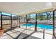 A screened pool enclosure with a clear view of the pool and surrounding backyard at 2233 Curlew Rd, Dunedin, FL 34698