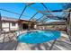 Beautiful screened-in pool view from the side at 2233 Curlew Rd, Dunedin, FL 34698