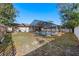 Backyard view of a screened-in pool and patio area, surrounded by a grassy lawn at 2233 Curlew Rd, Dunedin, FL 34698