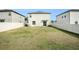 Spacious backyard with grassy area and home view at 3873 Gainer Spring Avenue, New Port Richey, FL 34653