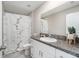 Clean bathroom with a white vanity, shower, and marble-patterned curtain at 3873 Gainer Spring Avenue, New Port Richey, FL 34653