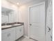 Bathroom features double vanity with granite countertop at 3873 Gainer Spring Avenue, New Port Richey, FL 34653