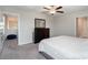 Main bedroom with plush carpet, ceiling fan, and access to loft at 3873 Gainer Spring Avenue, New Port Richey, FL 34653