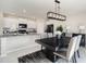 Dining room with black table, gray chairs, and modern chandelier at 3873 Gainer Spring Avenue, New Port Richey, FL 34653