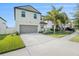 Two-story house with gray siding, two-car garage, and landscaped yard at 3873 Gainer Spring Avenue, New Port Richey, FL 34653
