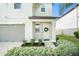 Front entryway with light beige door and wreath at 3873 Gainer Spring Avenue, New Port Richey, FL 34653
