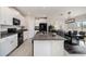 Modern kitchen with white cabinets, granite countertops and island at 3873 Gainer Spring Avenue, New Port Richey, FL 34653
