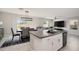 Kitchen boasts an island, granite countertops, and stainless steel appliances at 3873 Gainer Spring Avenue, New Port Richey, FL 34653